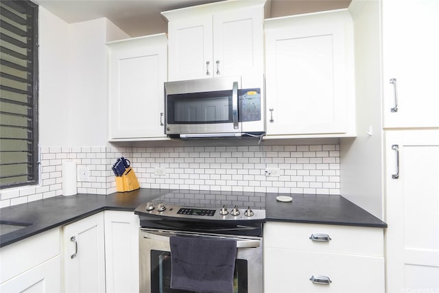 6770 Hawaii Kai Dr Unit 905, Honolulu, HI 96825 - kitchen with appliances with stainless steel finishes, dark countertops, tasteful backsplash, and white cabinetry