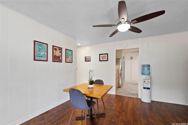 dining area featuring baseboards, a ceiling fan, and hardwood / wood-style flooring