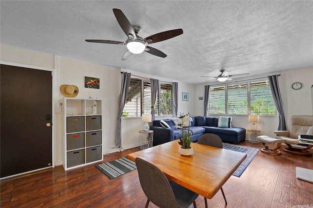 living room with hardwood / wood-style flooring, baseboards, a textured ceiling, and ceiling fan