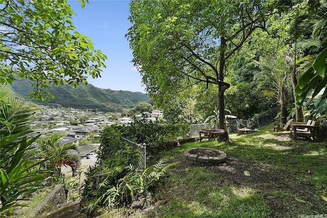 1671 Mahani Loop, Honolulu, HI 96819 - view of yard featuring a fire pit, fence, and a mountain view