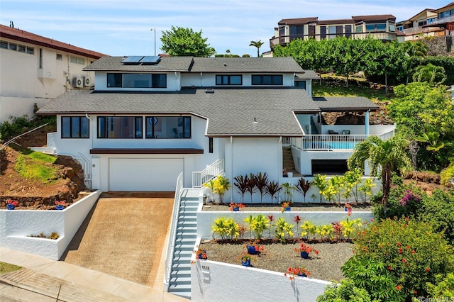 1772 Kumakani Loop, Honolulu, HI 96821 - view of front of house with stairway, roof with shingles, stucco siding, solar panels, and concrete driveway