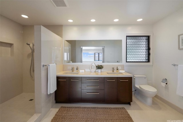 bathroom featuring recessed lighting, visible vents, toilet, a sink, and walk in shower
