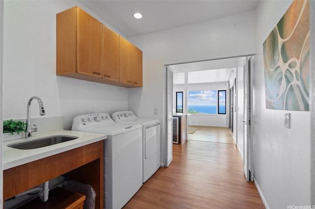1772 Kumakani Loop, Honolulu, HI 96821 - laundry area with cabinet space, washer and dryer, light wood-style flooring, recessed lighting, and baseboards