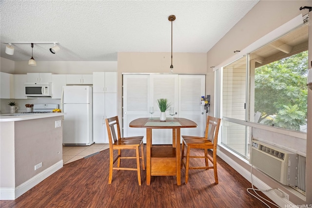 91-568 Puamaeole St Unit 50T, Ewa Beach, HI 96706 - dining room featuring wood finished floors, a textured ceiling, baseboards, and cooling unit