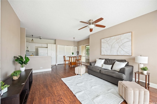 91-568 Puamaeole St Unit 50T, Ewa Beach, HI 96706 - living room featuring ceiling fan, dark wood finished floors, baseboards, and a textured ceiling