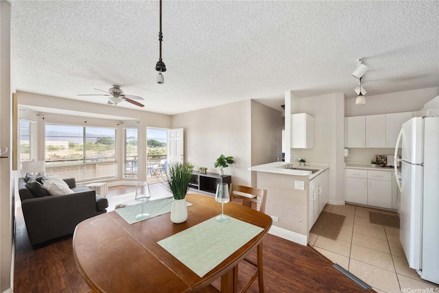 91-568 Puamaeole St Unit 50T, Ewa Beach, HI 96706 - dining area with a textured ceiling, ceiling fan, light wood-style flooring, and track lighting