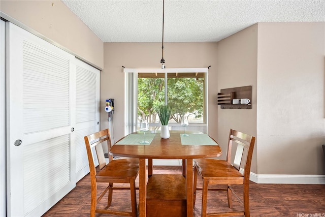 91-568 Puamaeole St Unit 50T, Ewa Beach, HI 96706 - dining area with wood finished floors, a textured ceiling, and baseboards
