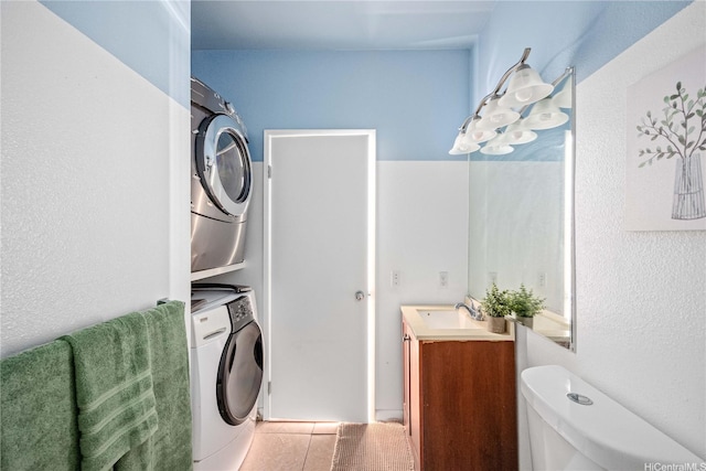 91-568 Puamaeole St Unit 50T, Ewa Beach, HI 96706 - washroom with stacked washing machine and dryer and light tile patterned floors