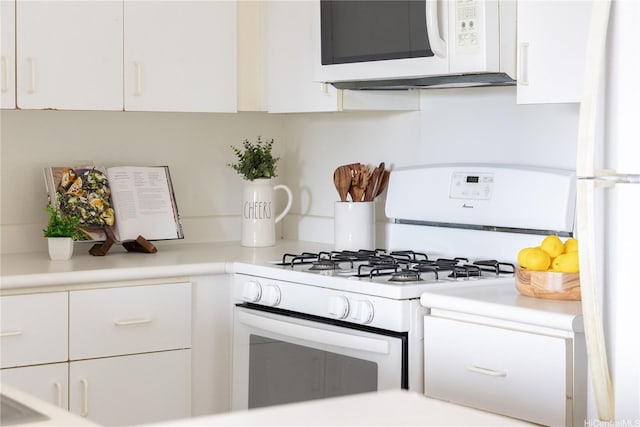 91-568 Puamaeole St Unit 50T, Ewa Beach, HI 96706 - kitchen featuring white appliances, white cabinets, and light countertops