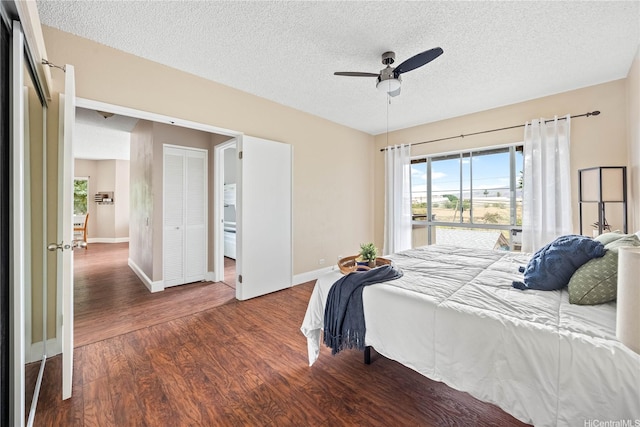 91-568 Puamaeole St Unit 50T, Ewa Beach, HI 96706 - bedroom with wood finished floors, a textured ceiling, baseboards, a ceiling fan, and ensuite bath