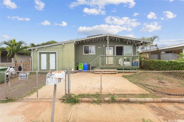 91-688 Kilinahe St, Ewa Beach, HI 96706 - view of front facade with a gate, french doors, and a fenced front yard