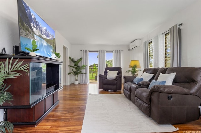 living room featuring an AC wall unit and wood finished floors