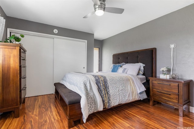 bedroom featuring ceiling fan, wood finished floors, and a closet