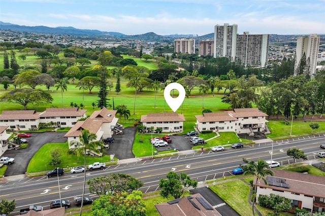 drone / aerial view with view of golf course and a mountain view