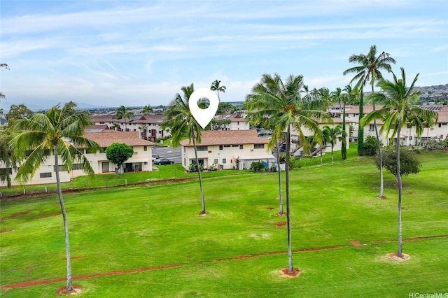 view of community with a yard and a residential view