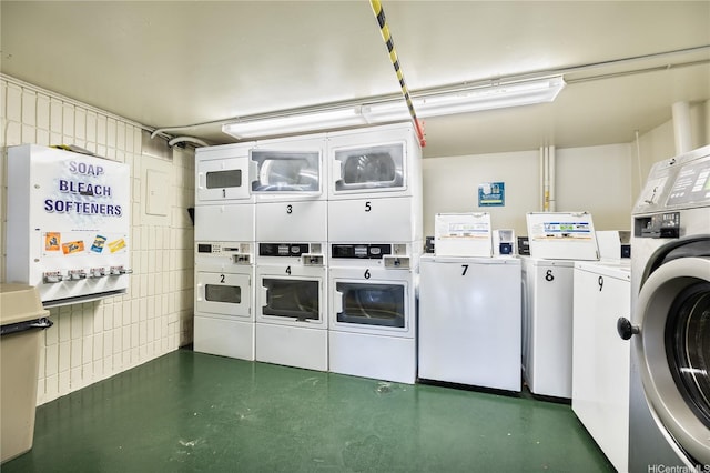 shared laundry area with stacked washing maching and dryer and washing machine and dryer