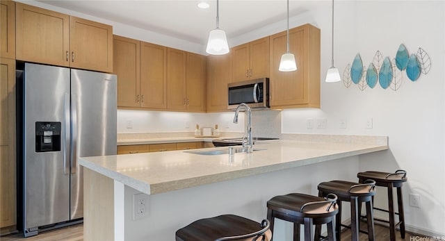 84-928 Maiola St Unit 76, Waianae, HI 96792 - kitchen featuring appliances with stainless steel finishes, light countertops, a peninsula, and a breakfast bar area