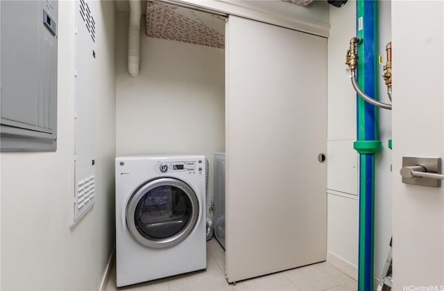 washroom with washer / dryer, light tile patterned floors, and laundry area