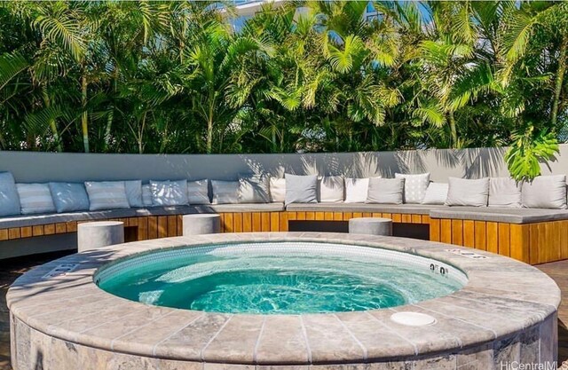 view of swimming pool featuring an outdoor hot tub