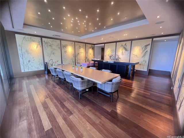 interior space featuring visible vents, hardwood / wood-style flooring, a tray ceiling, and recessed lighting