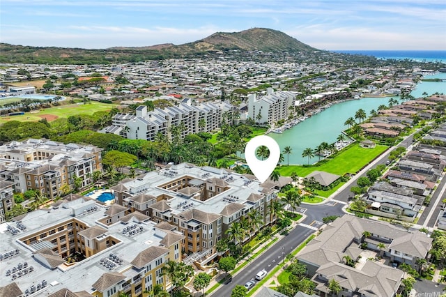 birds eye view of property with a water and mountain view