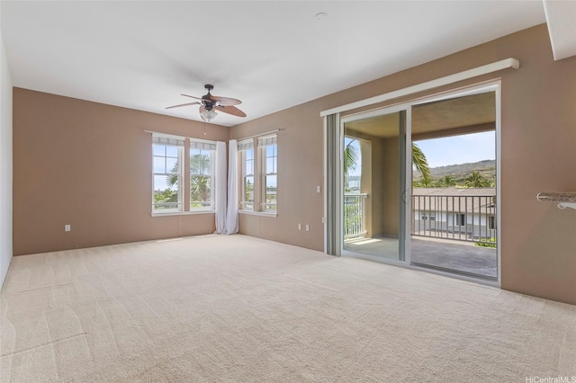 spare room featuring a ceiling fan and carpet flooring
