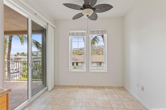 unfurnished dining area with light tile patterned flooring, ceiling fan, and baseboards