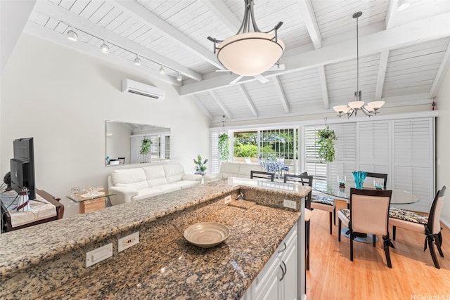 44-3612 Nilu St Unit 9/2, Kaneohe, HI 96744 - kitchen with light wood-style floors, a wall unit AC, wood ceiling, open floor plan, and dark stone countertops