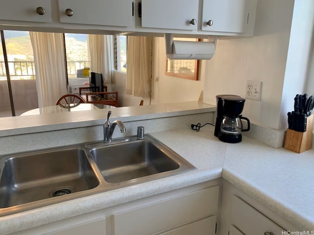 2240 Kuhio Ave Unit 2305, Honolulu, HI 96815 - kitchen featuring light countertops, white cabinets, and a sink