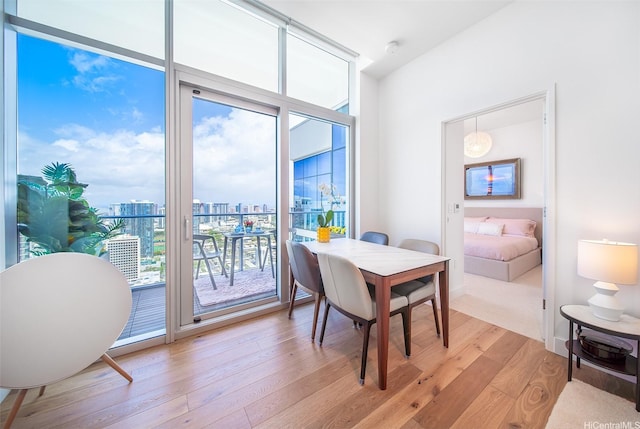 dining area with a city view and light wood-type flooring