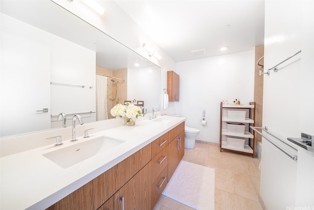 full bath with toilet, recessed lighting, double vanity, and a sink