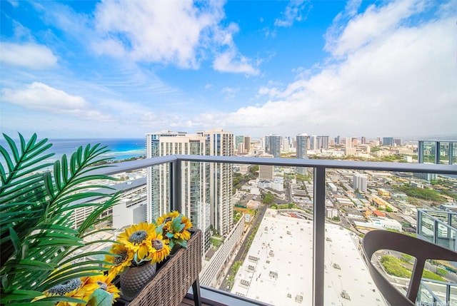 balcony featuring a city view and a water view