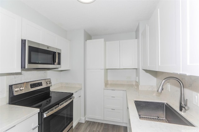 3161 Ala Ilima St Unit 403, Honolulu, HI 96818 - kitchen featuring white cabinets, stainless steel appliances, and a sink