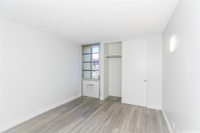 3161 Ala Ilima St Unit 403, Honolulu, HI 96818 - unfurnished bedroom featuring baseboards, wood finished floors, and a closet
