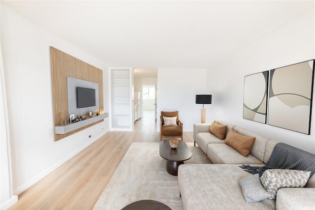 living area with wood finished floors and baseboards