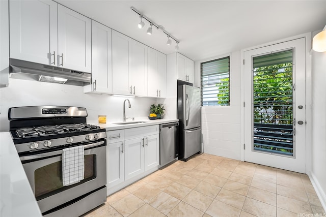 3131 Pualei Cir Unit 15, Honolulu, HI 96815 - kitchen with stainless steel appliances, under cabinet range hood, a sink, light countertops, and white cabinetry