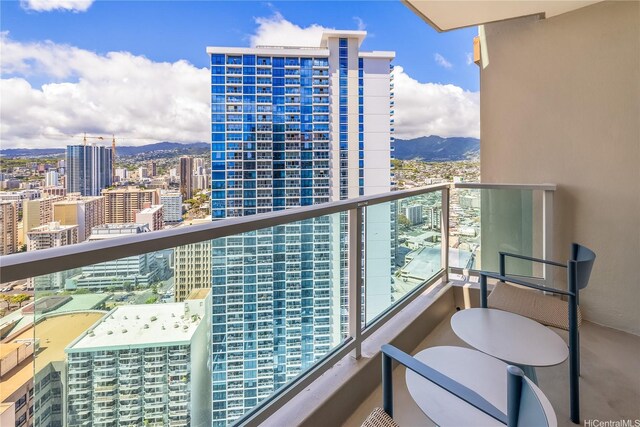 balcony featuring a mountain view and a city view