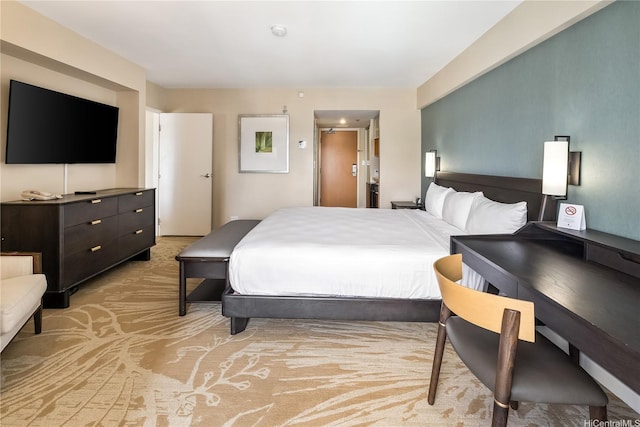 bedroom featuring light carpet