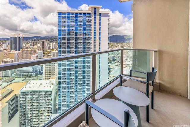 balcony featuring a mountain view and a view of city