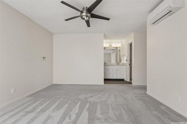 interior space with a ceiling fan, a textured ceiling, and a wall mounted AC
