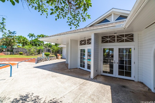 view of patio with french doors and fence