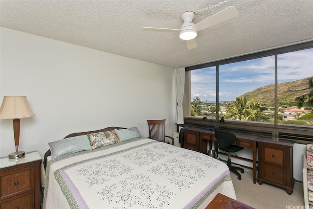 521 Hahaione St Unit 2-6J, Honolulu, HI 96825 - bedroom with ceiling fan, a textured ceiling, and light colored carpet