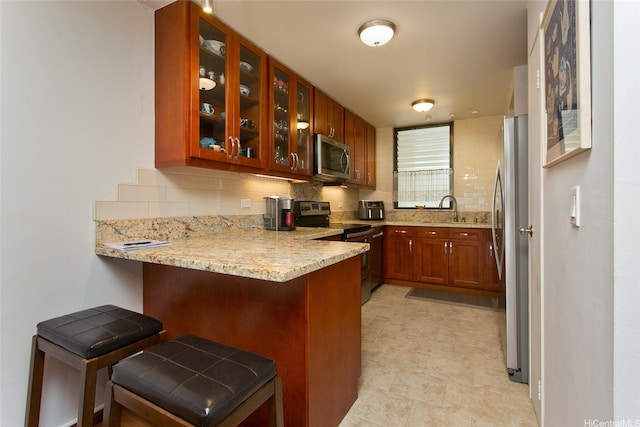 521 Hahaione St Unit 2-6J, Honolulu, HI 96825 - kitchen with a sink, stainless steel appliances, a peninsula, tasteful backsplash, and glass insert cabinets