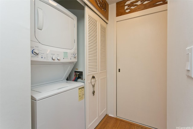 521 Hahaione St Unit 2-6J, Honolulu, HI 96825 - laundry room with stacked washer / drying machine, laundry area, and light wood-type flooring