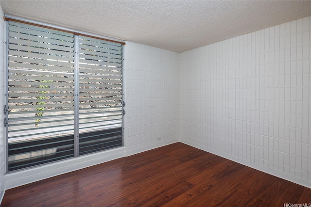 1524 Pensacola St Unit 217, Honolulu, HI 96822 - unfurnished room featuring dark wood-style flooring and a textured ceiling
