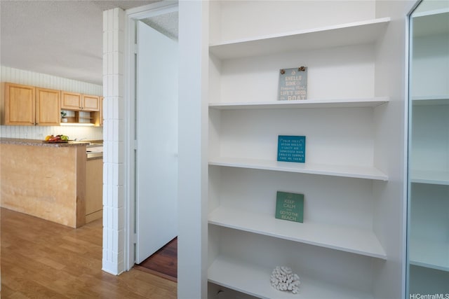 1524 Pensacola St Unit 217, Honolulu, HI 96822 - detailed view of open shelves, light brown cabinetry, wood finished floors, and decorative backsplash