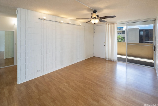 1524 Pensacola St Unit 217, Honolulu, HI 96822 - spare room with a textured ceiling, wood finished floors, and ceiling fan