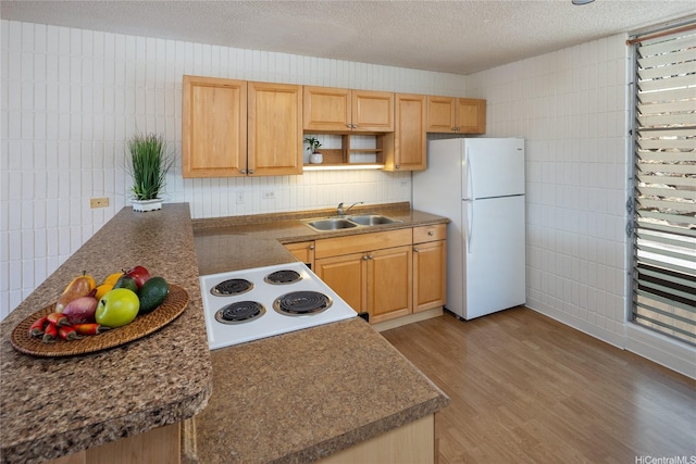 1524 Pensacola St Unit 217, Honolulu, HI 96822 - kitchen featuring freestanding refrigerator, range with electric stovetop, light wood-type flooring, a textured ceiling, and tile walls