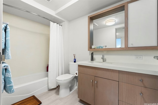 bathroom featuring toilet, shower / tub combo with curtain, vanity, and wood finished floors