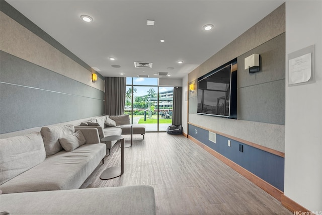 living room featuring recessed lighting, wood finished floors, visible vents, and floor to ceiling windows